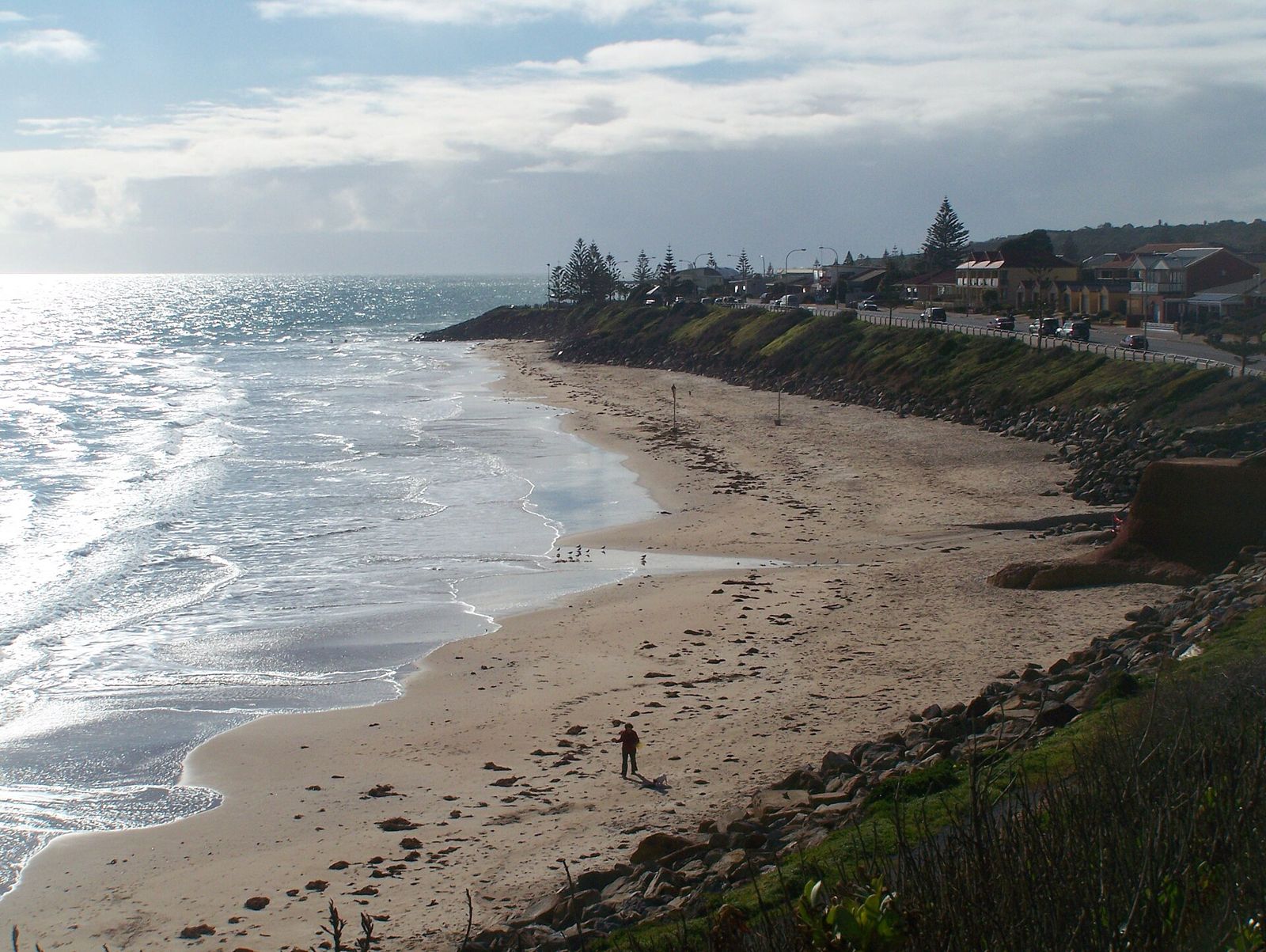 Waves rolling onto the beach at Christies Beach on a sunny day.
